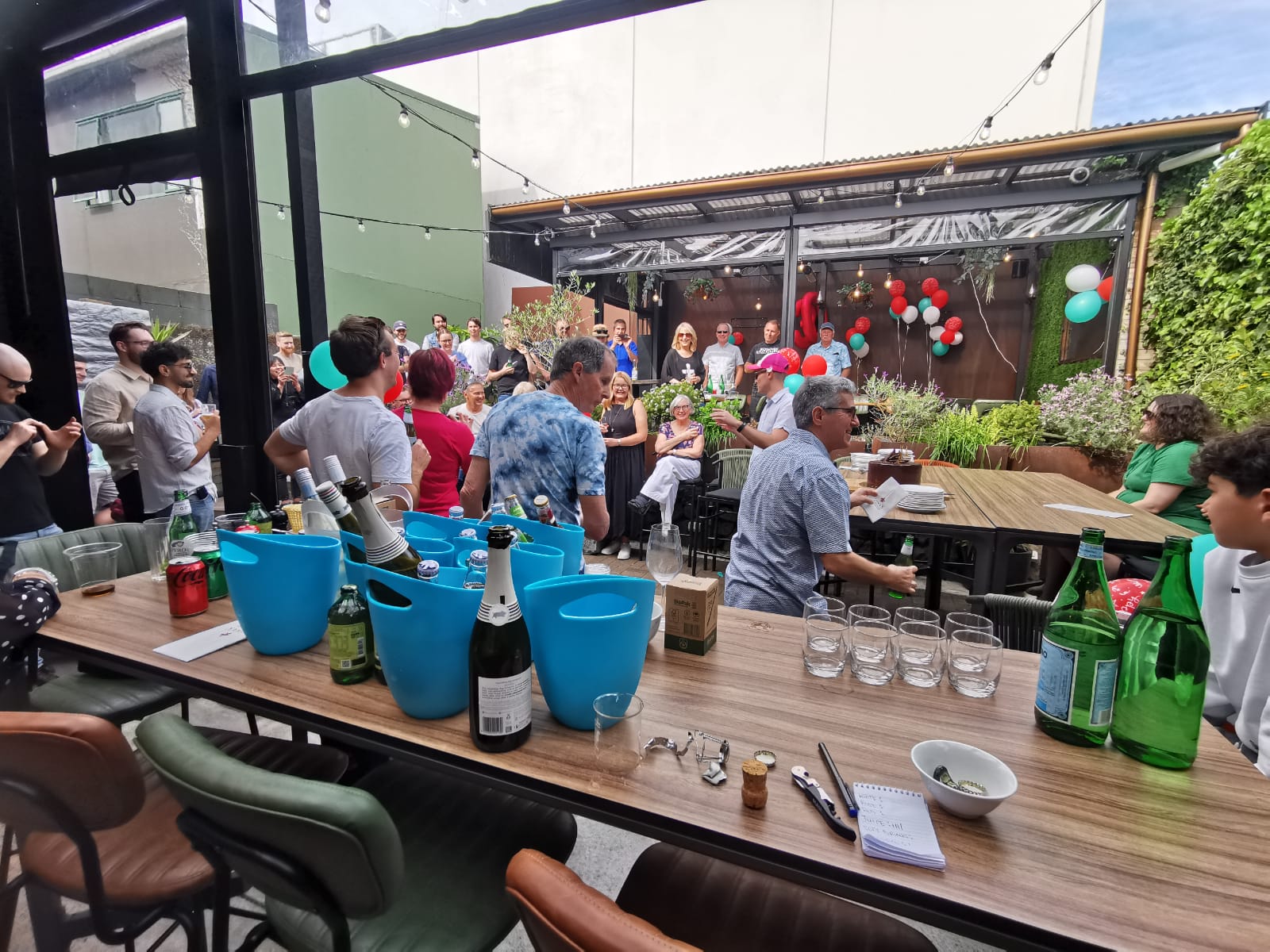 Balloons, a cake and a crowd at a Gina's Christmas party